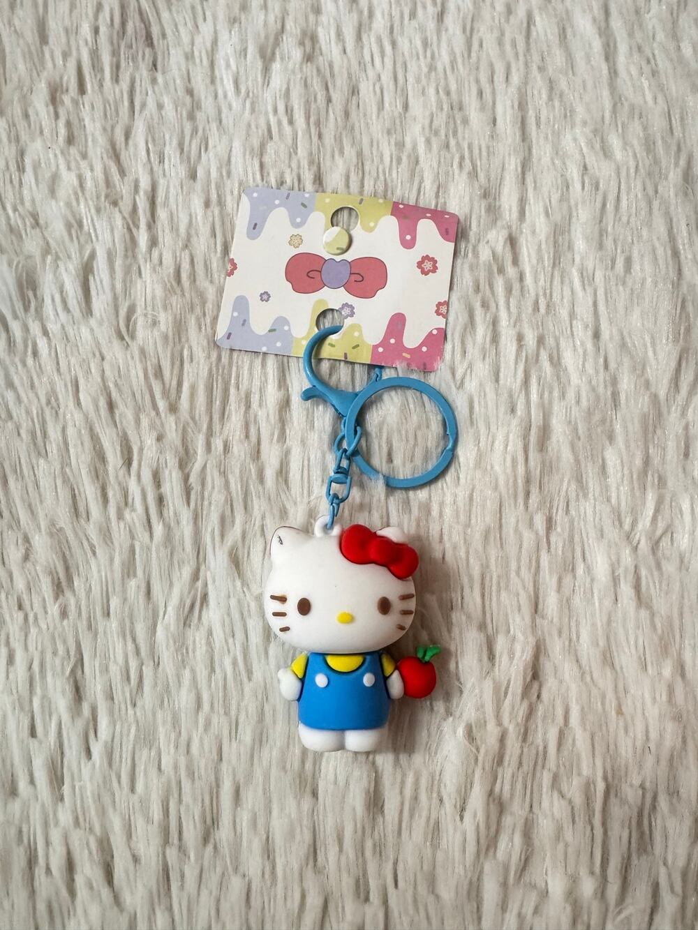 Classic Hello Kitty keychain blue overall and red bow and apple